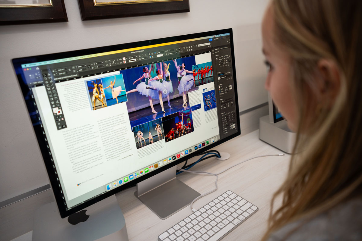 Student working on the yearbook in Adobe InDesign